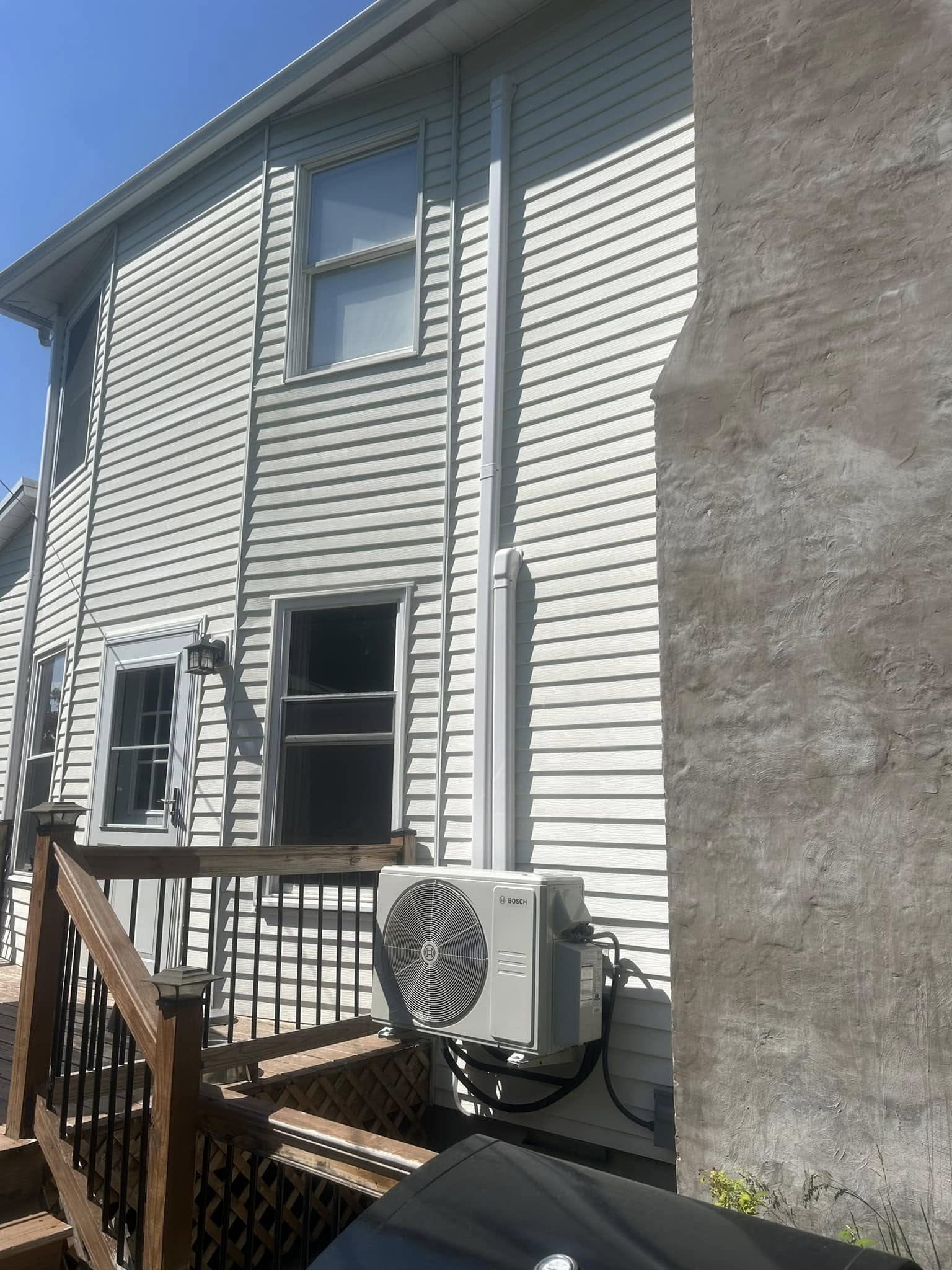 Side view of a wall-mounted outdoor air conditioning unit