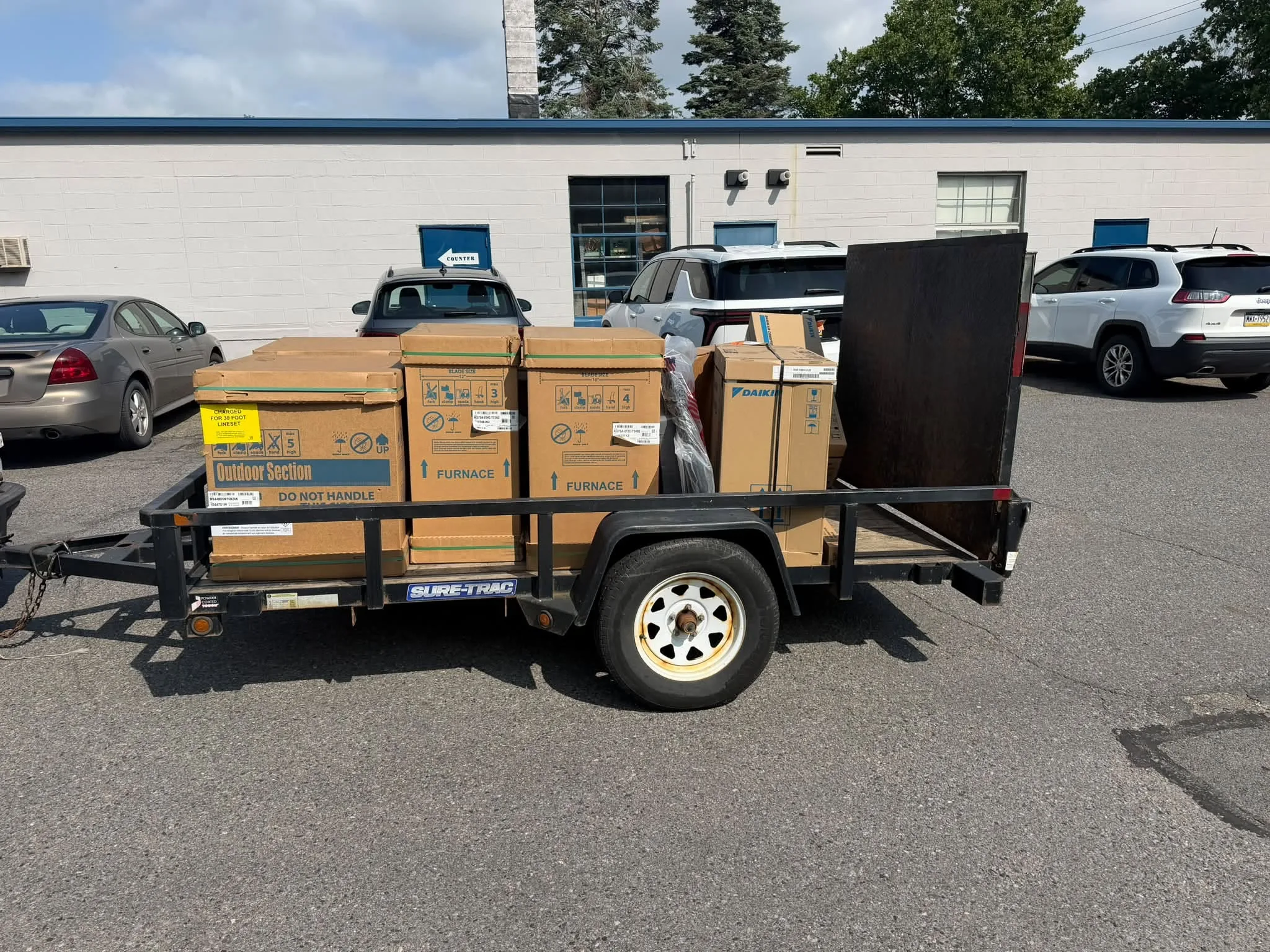 Boxed furnace and air conditioning equipment secured on a trailer