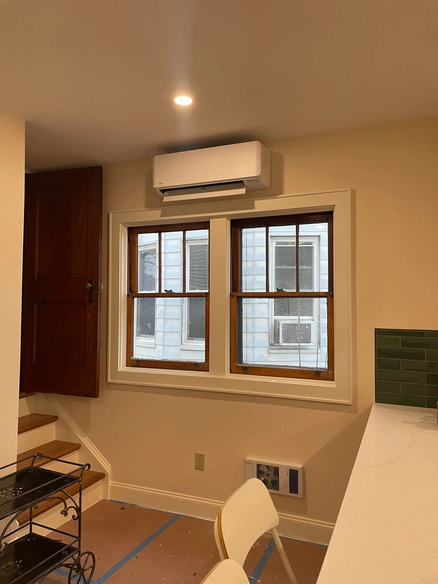 Finished Fujitsu indoor mini-split unit installation above a window
