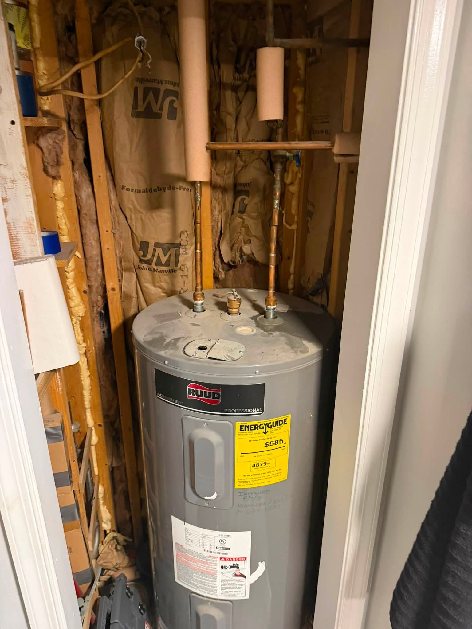Ruud water heater and connected piping in a utility space