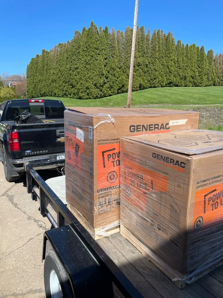Boxed Generac standby generators secured on a trailer
